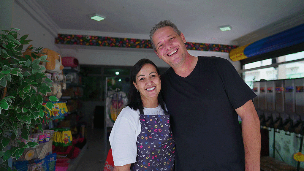 Man and Woman standing together smiling in a small business type shop